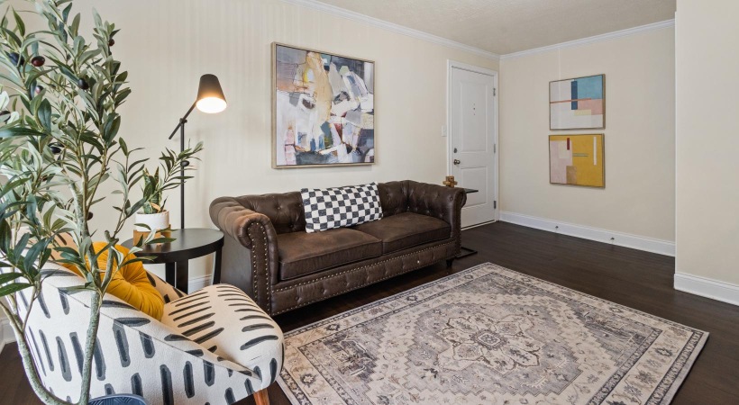 a living room with a couch and a rug