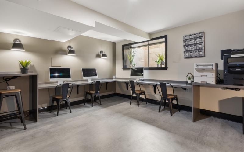a room with a desk and computers